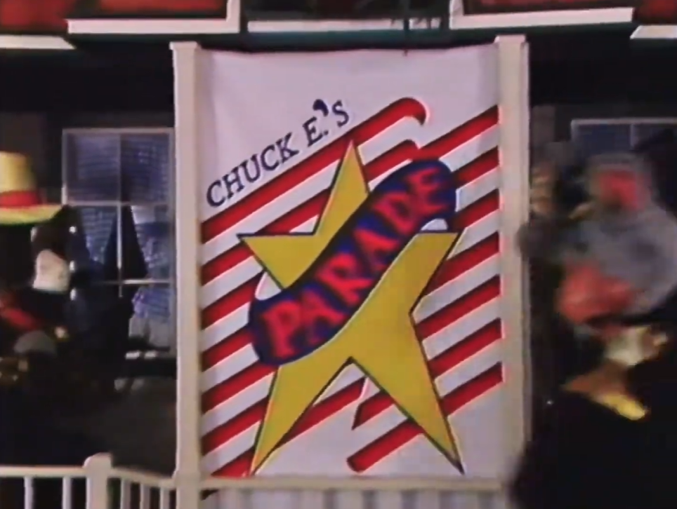 Chuck E.’s Parade Banner seen at Irving, TX (3903 W Airport Fwy).
