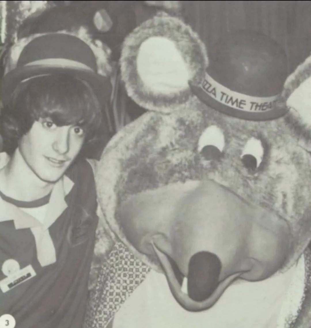 Employee posing with Chuck, featuring Lounge Helen Henny in the background.